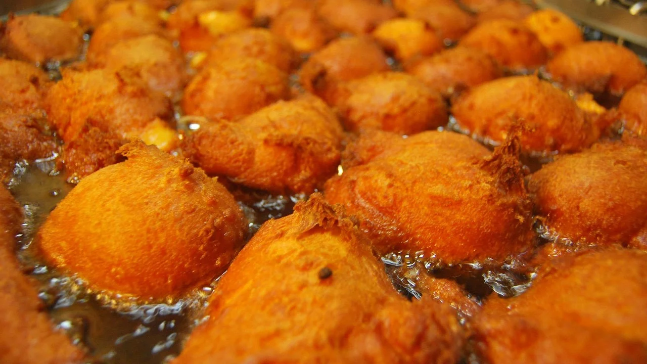 Pastéis fritando em óleo quente até ficarem dourados.