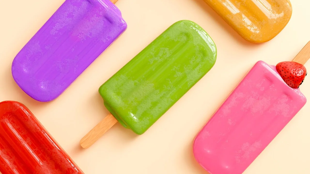 Picolés caseiros de frutas em moldes coloridos
